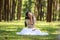 beautiful potrait asian woman siting and listening to headphone music in a pine forest and holding retro camera with rose flowers