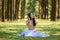 beautiful potrait asian woman siting and listening to headphone music in a pine forest and retro camera with rose flowers in frame