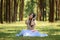 beautiful potrait asian woman siting and listening to headphone music in a pine forest and retro camera with rose flowers in frame