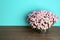 Beautiful potted chrysanthemum flowers on table against color background