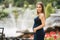 Beautiful pregnant lady in blue dress smile. Tenderness woman walk outside. Six months of pregnancy