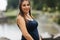 Beautiful pregnant lady in blue dress smile. Tenderness woman walk outside. Six months of pregnancy