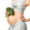 Beautiful pregnant woman big belly holding broccoli Pregnancy motherhood expectation healthy eating