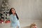 Beautiful pregnant woman childbirth on Christmas New Year holiday gifts