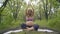 Beautiful pregnant woman doing prenatal yoga on nature outdoors. Sport, fitness, healthy lifestyle while pregnant