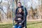 Beautiful pregnant woman and her handsome husband hugging the tummy on the swing
