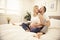 Beautiful pregnant woman and her handsome husband spending time together in bed