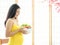 A beautiful pregnant woman in a Japanese room preparing a vegetable salad to eat for good health