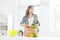 Beautiful pregnant woman in the kitchen with shopping bag and pineapple