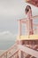 Beautiful pregnant woman on the lifeguard tower