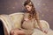 Beautiful pregnant woman with long blond hair wears elegant dress