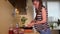 Beautiful pregnant woman peeling carrot vegetables in kitchen