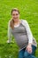 Beautiful pregnant woman relaxing in the park