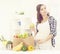 Beautiful pregnant woman with shopping bags in kitchen. Motherhood, pregnancy, maternity concept.