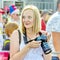 Beautiful pregnant woman soccer fan with camera in hands at the World Cup