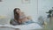 Beautiful pregnant woman touching belly home. Belly mother lying on bed pillows