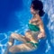 Beautiful pregnant woman underwater blue pool