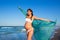 Beautiful pregnant woman walking on blue beach