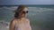 Beautiful pregnant woman walking on the ocean beach, Young woman waiting for her baby, stroking his stomach 4k