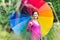 Beautiful pregnant woman walking under colorful umbrella