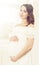 Beautiful pregnant woman in white dress. Motherhood, pregnancy,