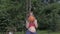 Beautiful pregnant young woman blow balloon in garden