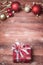 A beautiful present box, red and golden Christmas ornaments arra
