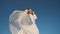 beautiful pretty pretty woman in white wedding dress spin in front of camera and flirting. shot from below of young lady