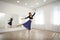 Beautiful professional dancer practicing moves in studio