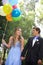 Beautiful Prom Couple Walking with Balloons Outside