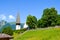 Beautiful Protestant church in Alpine resort Wengen, Switzerland photographed in the summer with green landscape. Mountains in the