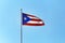 Beautiful Puerto Rican flag against blue sky