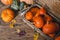 Beautiful pumpkins for Halloween are in a basket and chest in a wooden shed