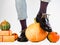 Beautiful pumpkins and men`s legs in stylish shoes