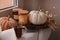 Beautiful pumpkins, tea and candles on window sill indoors