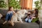 Beautiful purebreed dog, sand color American retriver lying on sofa with two kids, little girls in casual style clothes