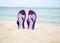 Beautiful, purple flip-flops on the beach