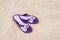 Beautiful purple flip-flops on the beach