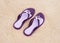 Beautiful purple flip-flops on the beach