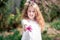 Beautiful purple flower close up. magnolia tree in blossom. Adorable girl smile in park with blossoming flowers. selective focus