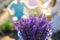 Beautiful purple lavender flowers on the summer field. Blurred Couple hugging hands, romantic love story. Warm and inspiration