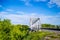 Beautiful railway bridge on a background of greenery and blue sky, perspective