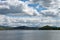 Beautiful rain clouds over the lake and the village on its shore.