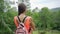 Beautiful Rain forest with a young woman traveler on the road into the forest Thailand. Female walks on a rain forest