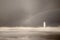 A beautiful rainbow appears over lighthouse