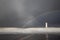 A beautiful rainbow appears over lighthouse