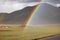 A beautiful rainbow appears on the prairie after the rain