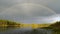 A beautiful rainbow over a forest lake.