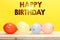 Beautiful realistic happy birthday greeting card with colorful party balloons, on wood table.