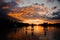 Beautiful rear view on group of people on sup boards which floating on the river at sunset